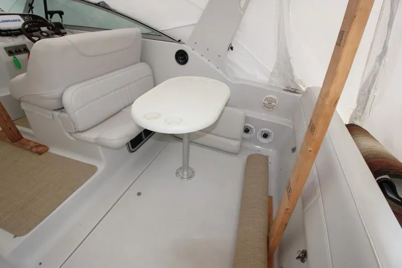 Slide: The Image of Interior of 2002 Crownline 290 CR boat with seating and table setup. - 3
