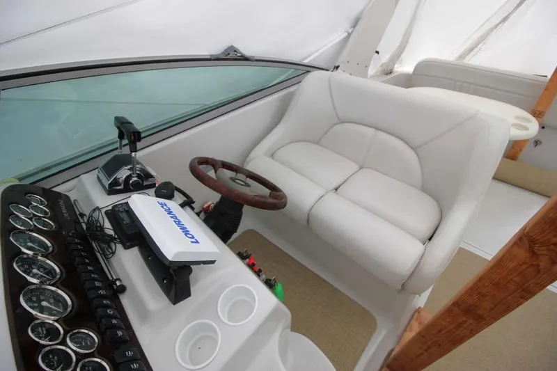 Slide: The Image of 2002 Crownline 290 CR boat cockpit with steering wheel and control panel. - 7