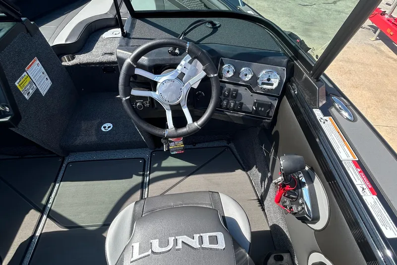 Slide: The Image of 2026 Lund 1875 Tyee boat cockpit with steering wheel and control panel. - 10