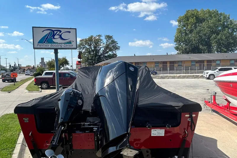 Slide: The Image of 2026 Lund 1875 Tyee boat at Premier Boating Center, covered and parked outdoors. - 11