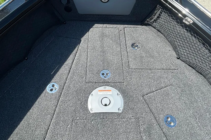 Slide: The Image of 2026 Lund 1875 Tyee boat interior with carpeted deck and storage compartments. - 13