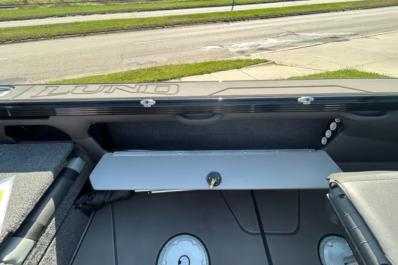 Slide: The Image of 2026 Lund 1875 Tyee boat interior, showcasing storage compartment and seating. - 23