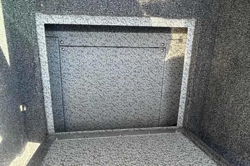 Slide: The Image of Interior storage compartment of 2026 Lund 1875 Tyee boat, featuring textured finish. - 24