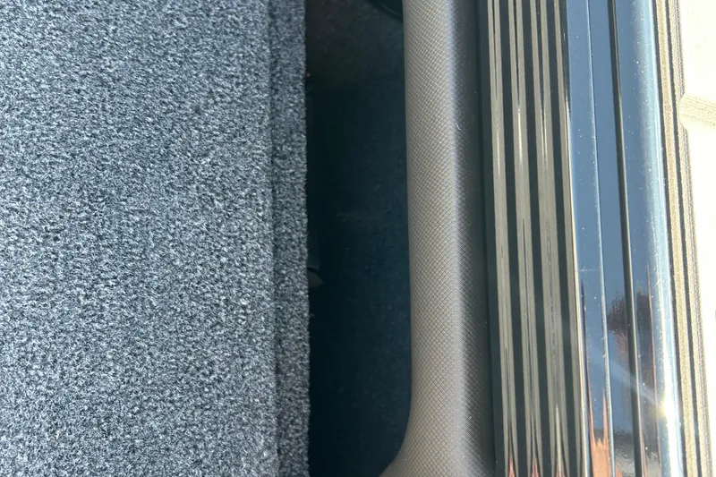 Slide: The Image of Carpeted interior and metallic trim of 2026 Lund 1875 Tyee boat. - 26