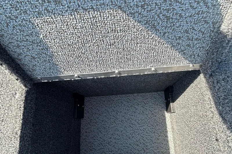 Slide: The Image of Interior view of 2026 Lund 1875 Tyee boat compartment with carpeted finish. - 29