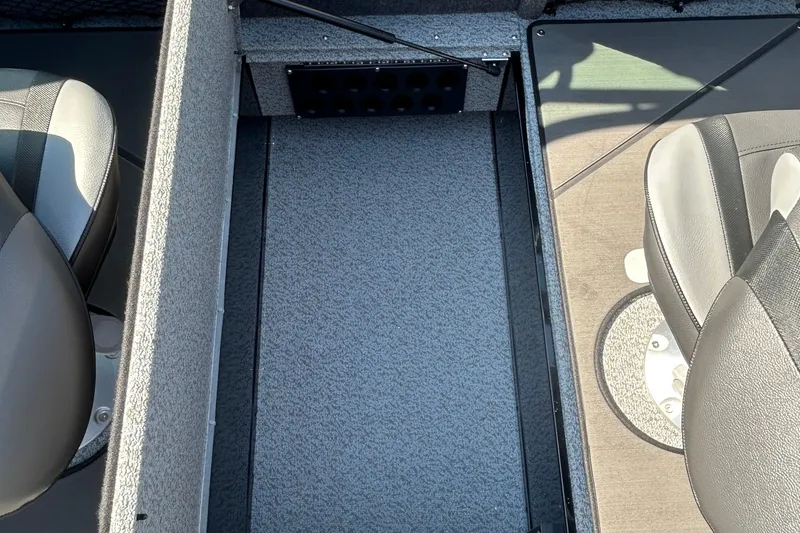 Slide: The Image of Interior view of 2026 Lund 1875 Tyee boat, featuring seating and carpeted flooring. - 31