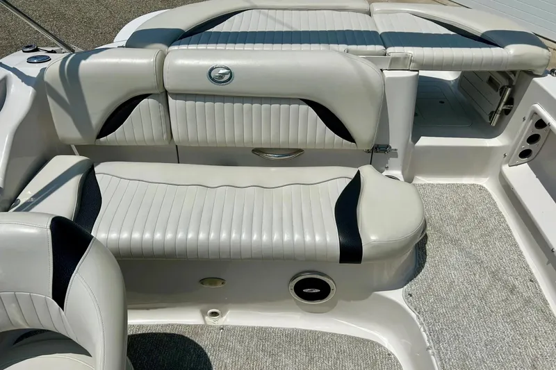 Slide: The Image of 2009 Starcraft Star Step boat interior with white and black cushioned seating. - 13