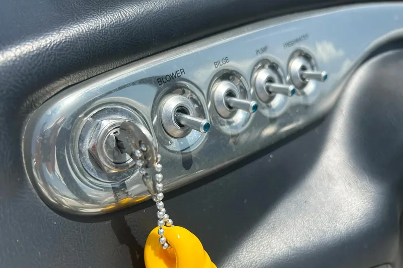 Slide: The Image of Control panel of a 2009 Starcraft Star Step boat with key and switches. - 17