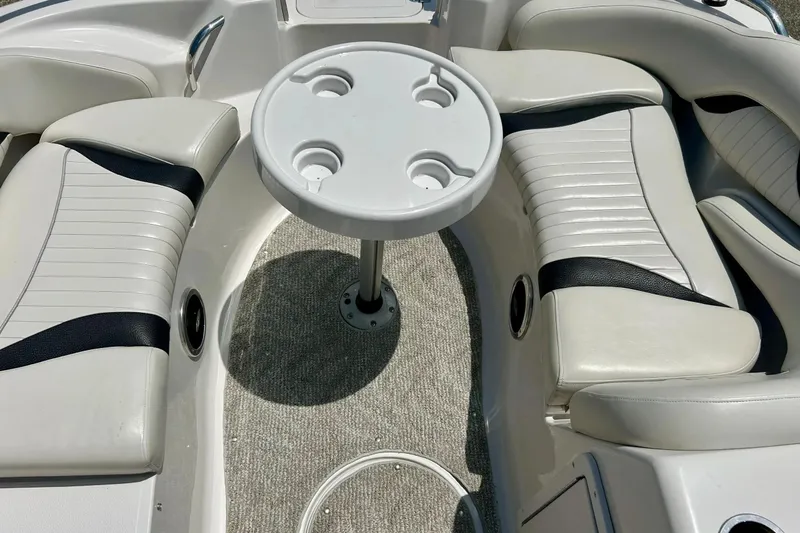 Slide: The Image of 2009 Starcraft Star Step boat interior with white seating and round table. - 21