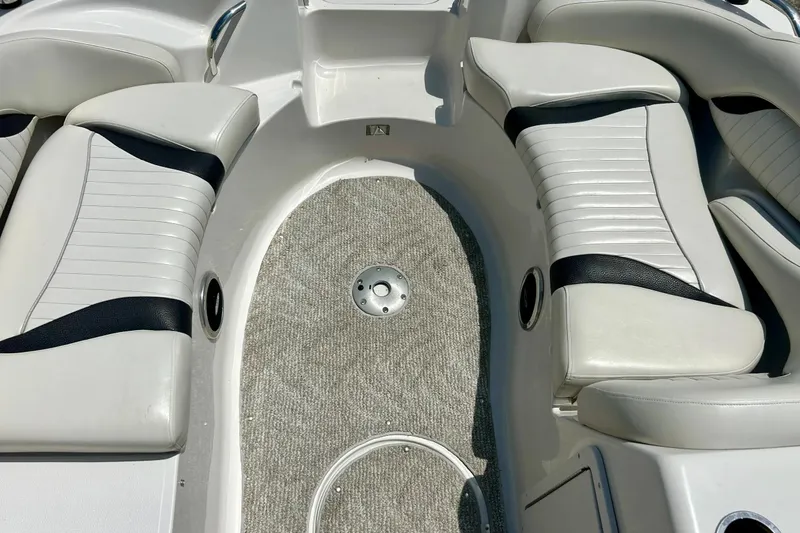 Slide: The Image of 2009 Starcraft Star Step boat interior with white and black seating and carpeted floor. - 22
