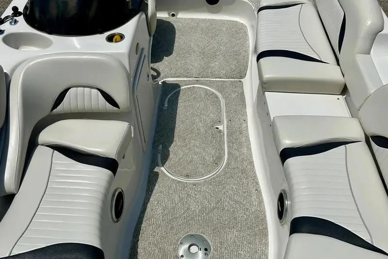 Slide: The Image of 2009 Starcraft Star Step boat interior with white and black seating, carpeted floor. - 23