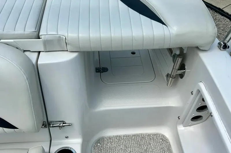 Slide: The Image of 2009 Starcraft Star Step boat interior with white cushioned seating and storage compartment. - 26
