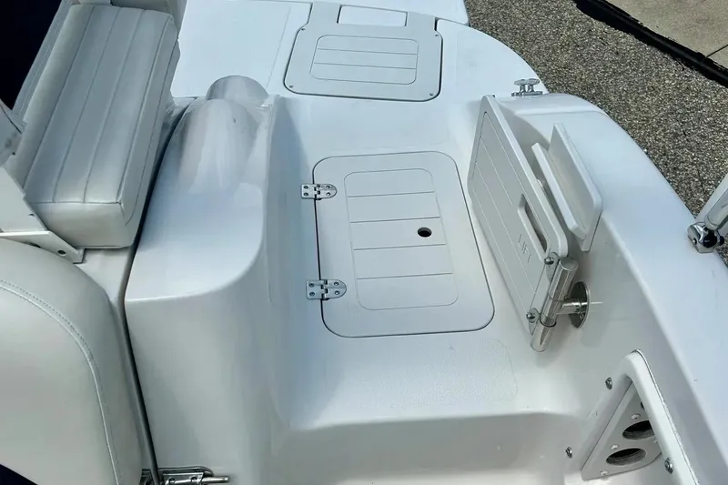 Slide: The Image of 2009 Starcraft Star Step boat interior with white seating and storage compartments. - 27