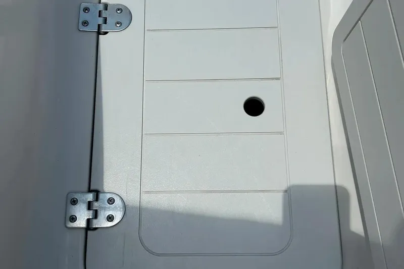 Slide: The Image of 2009 Starcraft Star Step boat hatch with metal hinges and circular opening. - 29