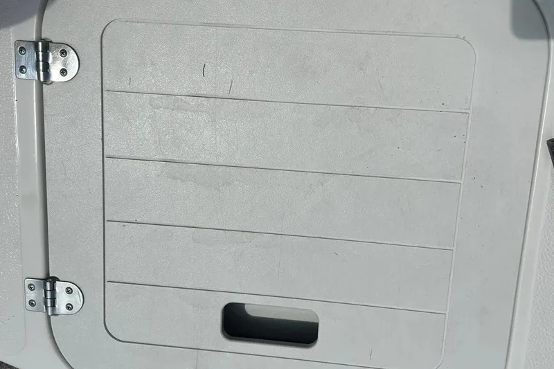 Slide: The Image of 2009 Starcraft Star Step boat hatch with metal hinges and handle. - 36