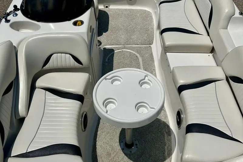 Slide: The Image of 2009 Starcraft Star Step boat interior with white seating and round table. - 7