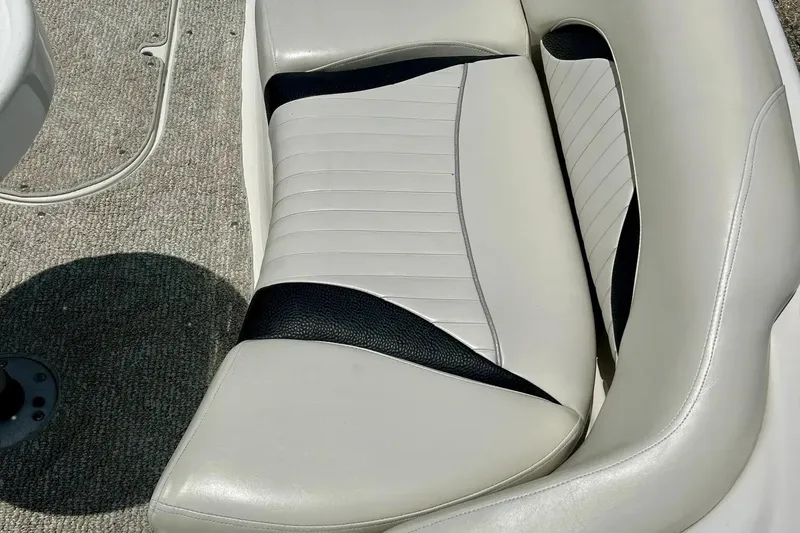 Slide: The Image of 2009 Starcraft Star Step boat seat with white and black upholstery on carpeted floor. - 8