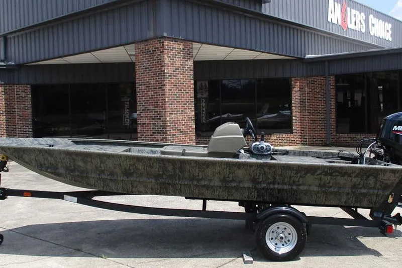 The Image of 2026 Tracker GRIZZLY® 1648 SC boat on trailer outside Anglers Choice store. - 1