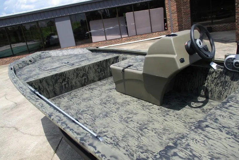 Slide: The Image of 2026 Tracker GRIZZLY® 1648 SC boat with camouflage design and steering console. - 7