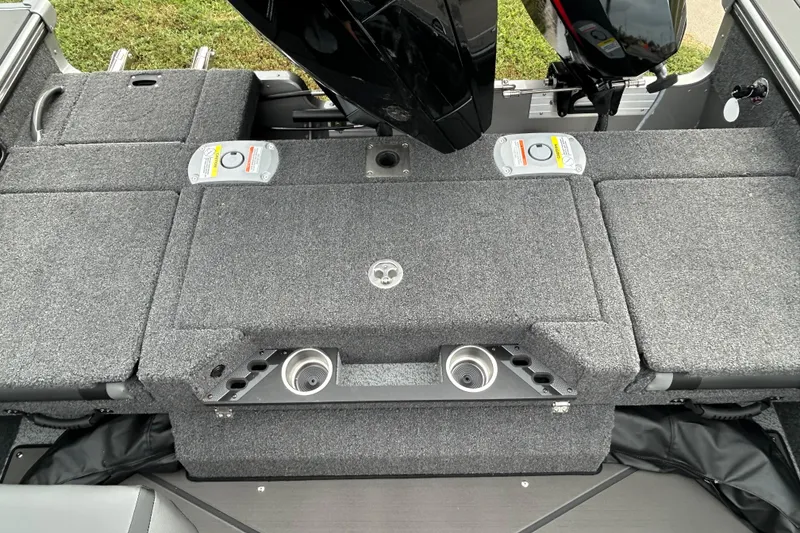 Slide: The Image of 2026 Lund 1875 Pro-V boat interior with gray carpeted deck and motor mount. - 11