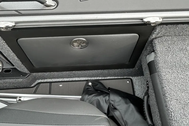 Slide: The Image of Interior of 2026 Lund 1875 Pro-V boat, featuring storage compartment and seating. - 12