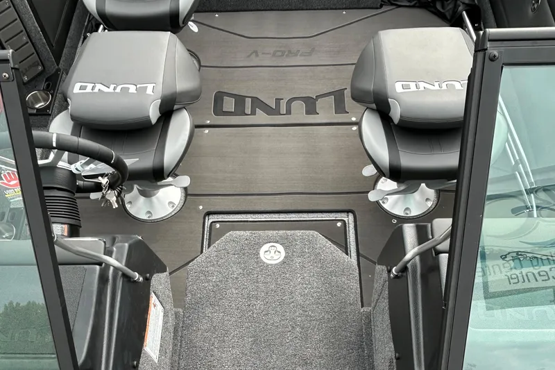 Slide: The Image of 2026 Lund 1875 Pro-V boat interior with branded seats and steering wheel. - 20