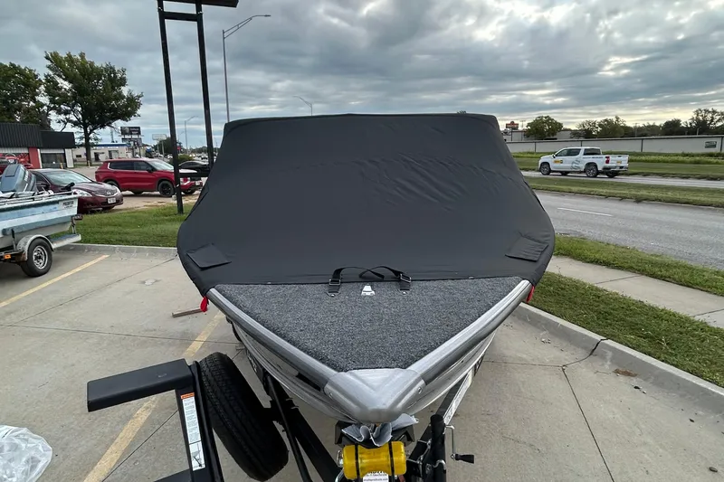Slide: The Image of 2026 Lund 1875 Pro-V boat with cover in parking lot, overcast sky. - 6