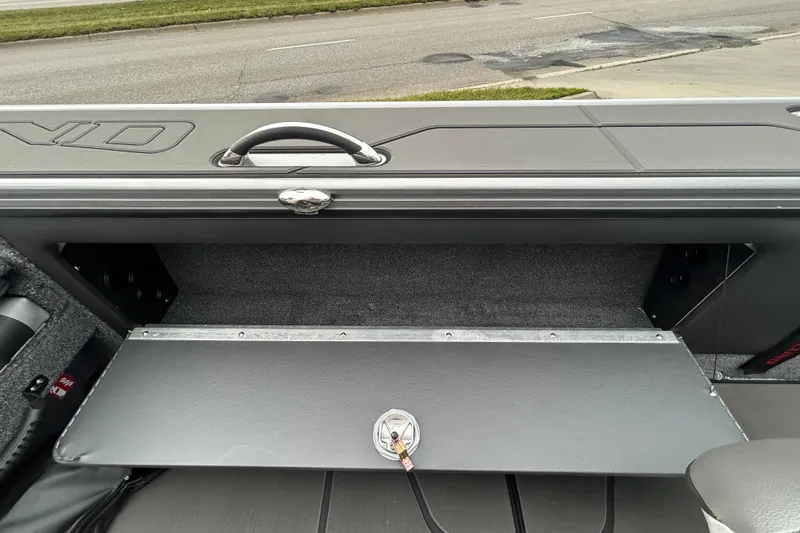 Slide: The Image of 2026 Lund 1875 Pro-V boat storage compartment with open lid, showcasing interior space. - 7