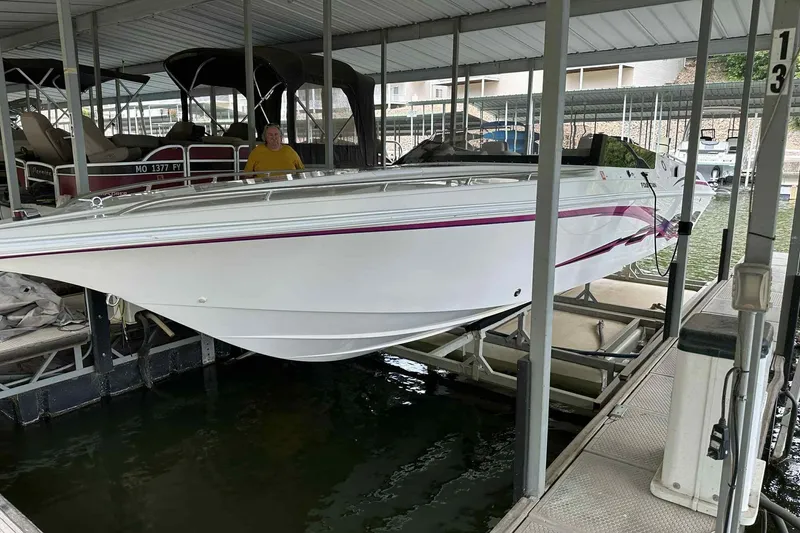 Slide: The Image of 1997 Fountain 29 Fever boat docked in a covered marina. - 0