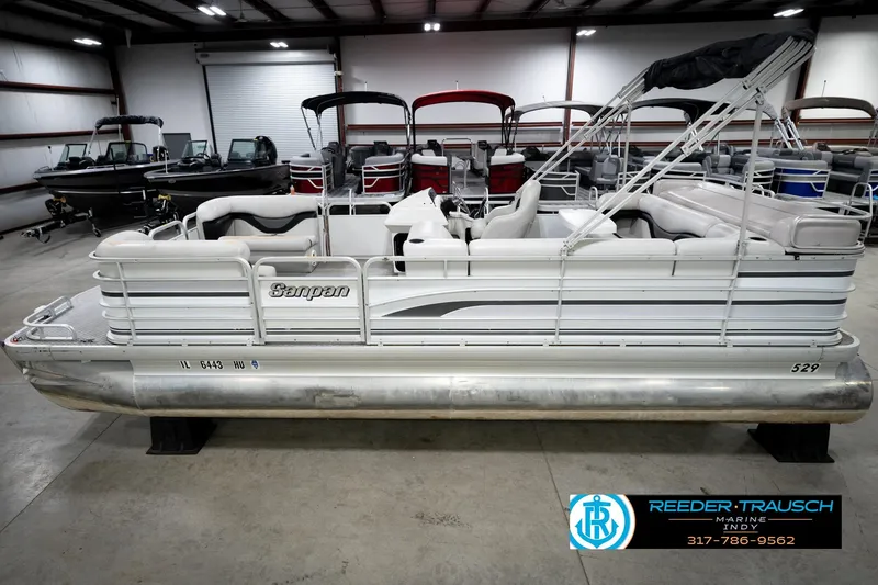 The Image of 1991 Godfrey SP2200 pontoon boat in showroom, side view with canopy. - 1