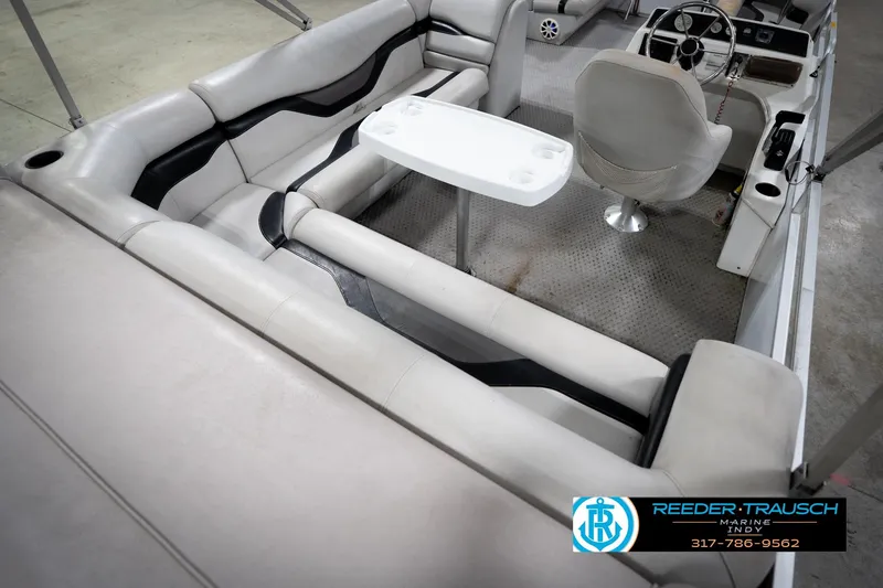 Slide: The Image of Interior of a 1991 Godfrey SP2200 boat with seating and steering wheel. - 13