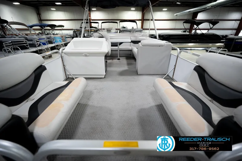 Slide: The Image of Interior of a 1991 Godfrey SP2200 pontoon boat with seating and storage. - 15