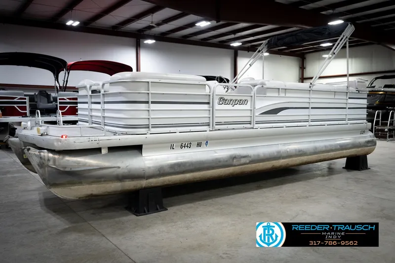 Slide: The Image of 1991 Godfrey SP2200 pontoon boat in indoor showroom, side view. - 2