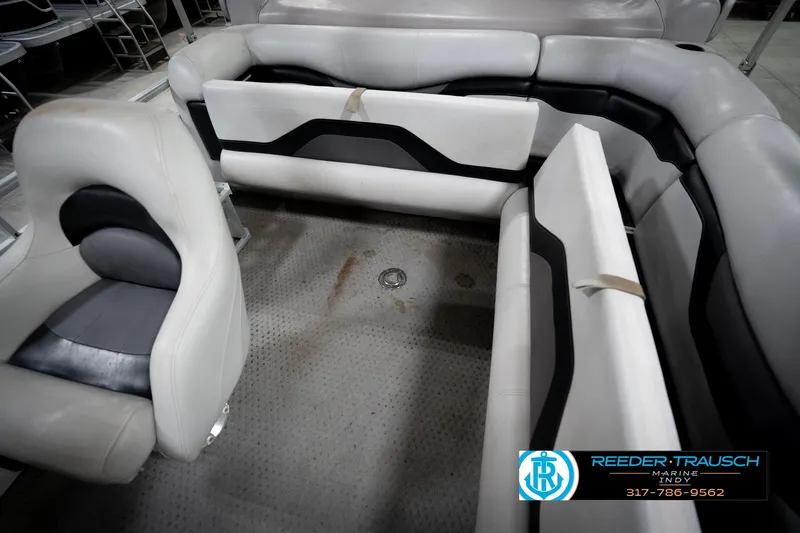 Slide: The Image of Interior of a 1991 Godfrey SP2200 boat with gray and black seating. - 24