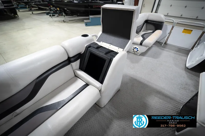 Slide: The Image of 1991 Godfrey SP2200 boat interior with open storage compartment and seating. - 26