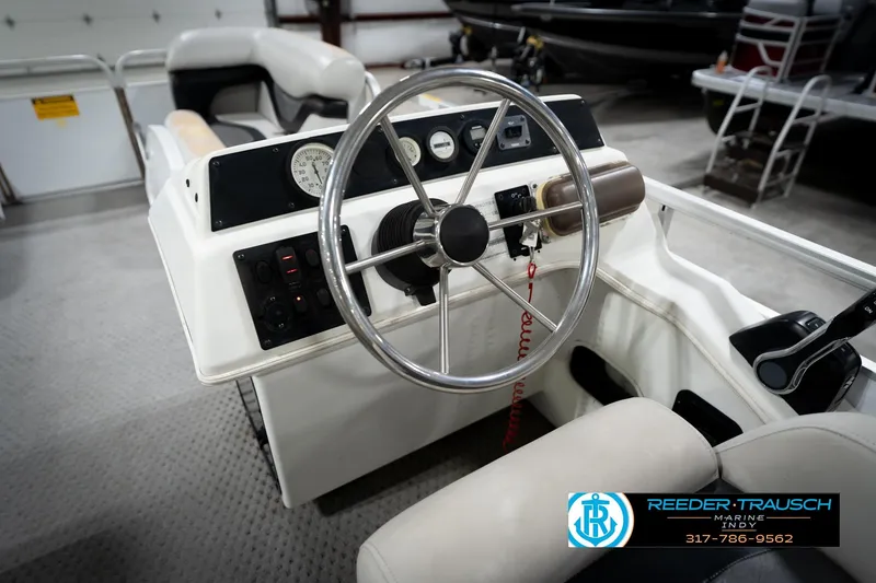 Slide: The Image of Steering console of a 1991 Godfrey SP2200 boat with gauges and controls. - 30