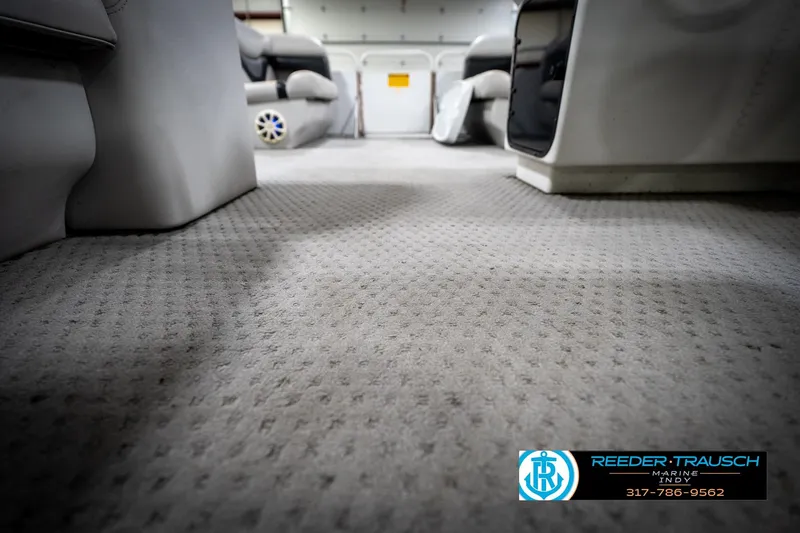Slide: The Image of Carpeted interior of a 1991 Godfrey SP2200 boat, featuring comfortable seating. - 46