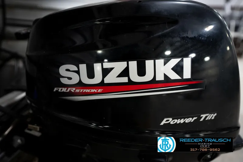 Slide: The Image of Suzuki four-stroke outboard motor with power tilt, featuring Reeder-Trausch Marine logo. - 50