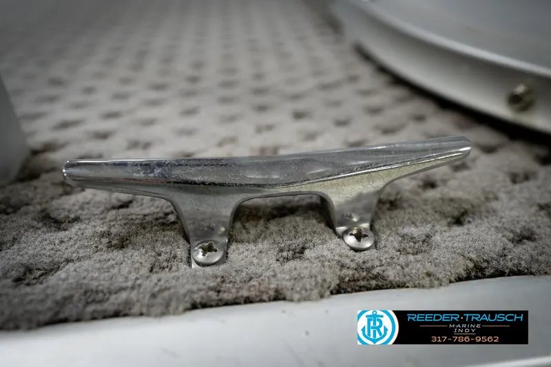 Slide: The Image of Chrome boat cleat on textured surface, Godfrey SP2200, 1991 model, Reeder-Trausch Marine logo. - 53
