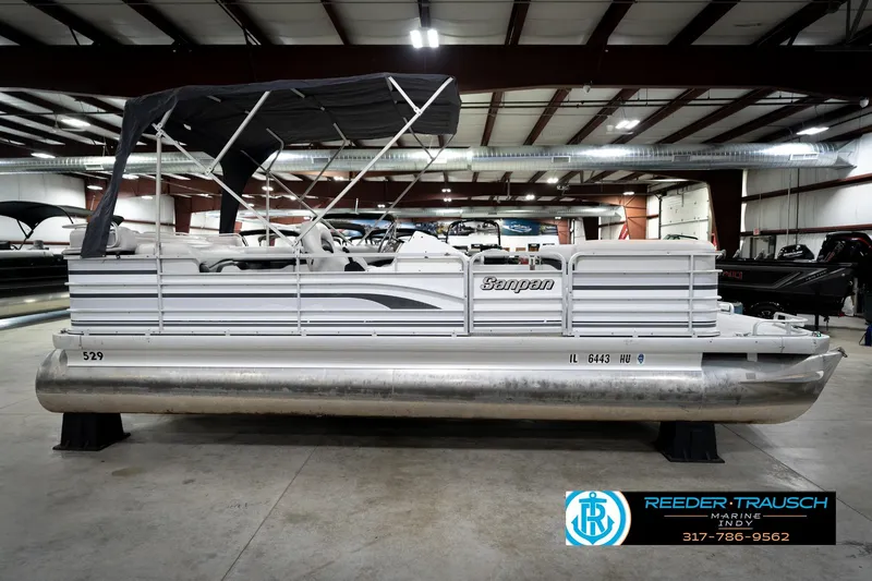 Slide: The Image of 1991 Godfrey SP2200 pontoon boat in indoor showroom, side view. - 6