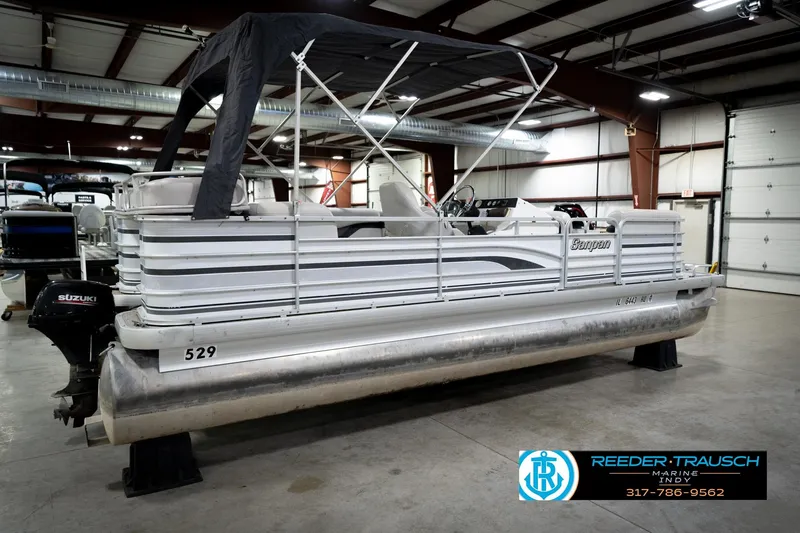 Slide: The Image of 1991 Godfrey SP2200 pontoon boat with Suzuki motor in indoor showroom. - 7