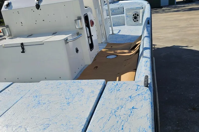 Slide: The Image of 2012 Desperado 22 Outlaw boat interior with blue-speckled design and deck features. - 3