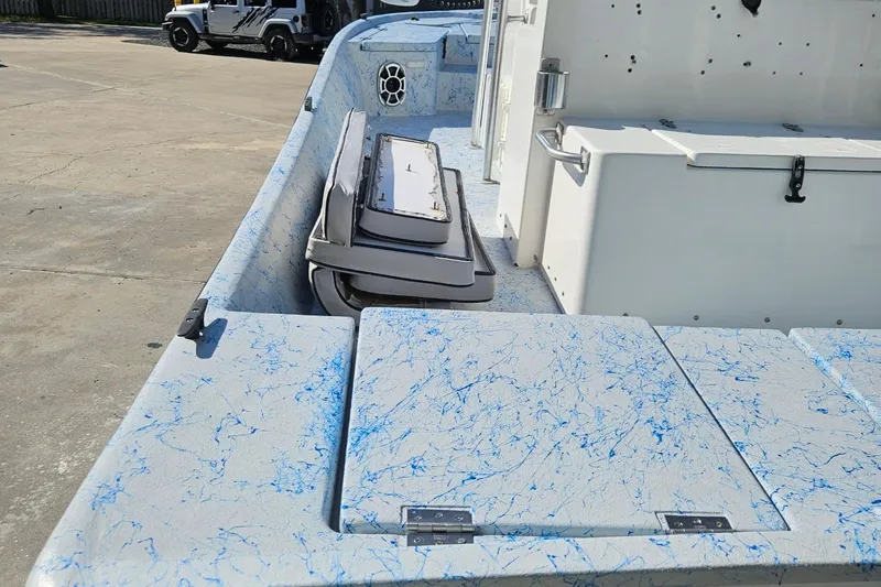 Slide: The Image of 2012 Desperado 22 Outlaw boat interior with blue marbled design and storage compartments. - 4