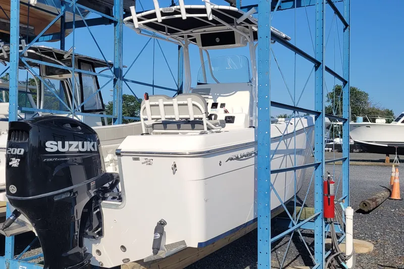Slide: The Image of 2022 Aquasport 2100 Center Console boat with Suzuki engine in storage rack. - 15