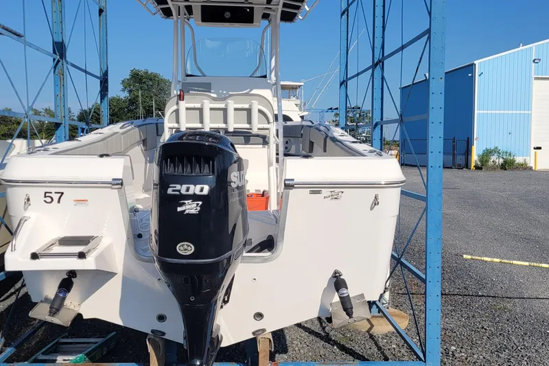 Slide: The Image of 2022 Aquasport 2100 Center Console boat with 200 HP engine in storage. - 17