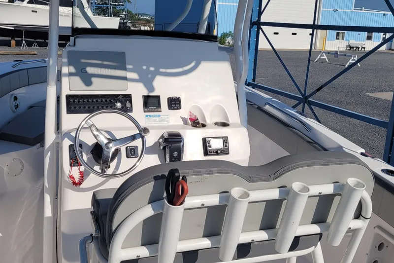 Slide: The Image of 2022 Aquasport 2100 Center Console boat interior with steering wheel and control panel. - 18
