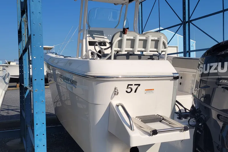 Slide: The Image of 2022 Aquasport 2100 Center Console boat with Suzuki engine in a marina. - 19