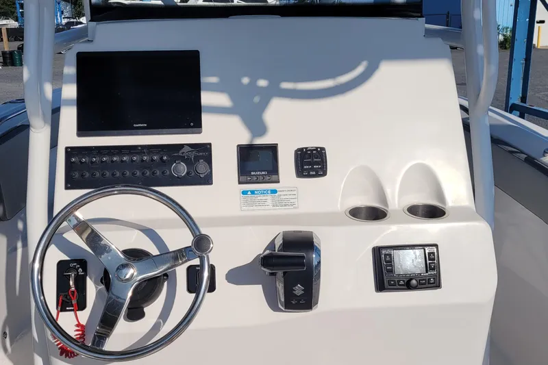 Slide: The Image of 2022 Aquasport 2100 Center Console dashboard with steering wheel and electronic controls. - 22