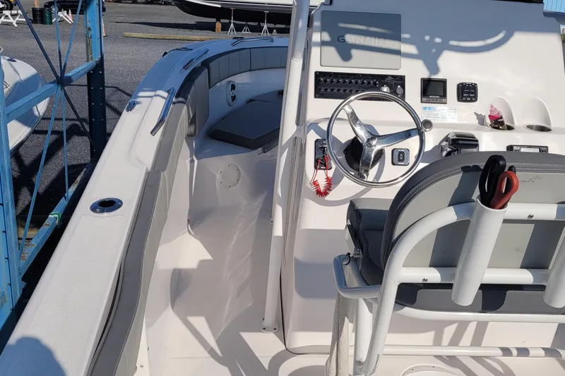 Slide: The Image of 2022 Aquasport 2100 Center Console boat interior with steering wheel and controls. - 23