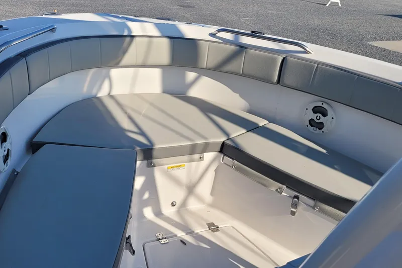 Slide: The Image of 2022 Aquasport 2100 Center Console boat interior with cushioned seating and speaker. - 29